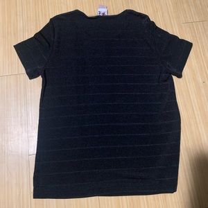Black polyester stretchy shirt. Can be dressed up, or worn as is. Tight fitting.